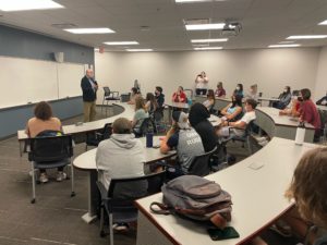 Dr. deGraff gives a brief lecture to current UMW students at the unveiling of the new business classroom named for him in Woodard Hall. Photo courtesy of Rob and Sarah Strassheim.