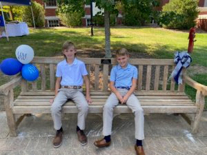Coby’s sons, Boice and Cole, sitting on their dad’s bench after the dedication ceremony last fall. Photo courtesy of John Anstey.