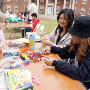 Hazel Lam-Mackintosh and Harper Thaden (left) make bead bracelets with UMW students Jenny Vuong and Boramy Meng at last year's Multicultural Fair. Challenges and matches during Mary Wash Giving Day will help ensure favorite campus events - and other Mary Washington traditions - continue. #MaryWashDay #TogetherUMW