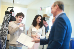 Seniors Oscar León and Mina Sollars chat about costumes from UMW Theatre productions with Mark Ingrao '81 and Lisa Taylor '85 during the Student Showcase. Photo by Karen Pearlman Photography.