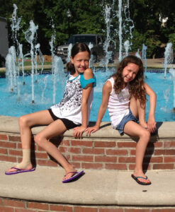 Daughters Ally (left) and Danni at the fountain on Palmieri Plaza in 2014.