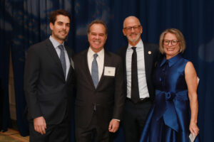 President Troy Paino and wife Kelly pose with Ron Pohl, attorney and friend of Irene Piscopo Rodgers '59, and his son, Remy Pohl, a 2016 alum of Mary Washington. Photo by Karen Pearlman Photography.