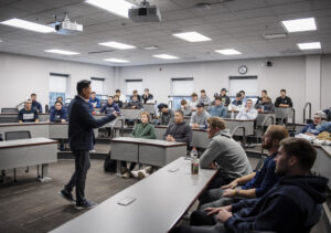 Jin Wong speaks to the UMW baseball team in the Leigh Frackleton Classroom in the College of Business. Photo by Tom Rothenberg.