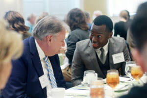 Aloysious Kabonge '26, who received the Thomas Howard and Elizabeth Merchent Tardy Scholarship, among others, chats during lunch with his donor, Al Merchent. Photo by Karen Pearlman.