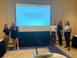 Sofia (far right) with psychology classmates (from left) Valeria Duque, Dayton Keffer, Katherine Blair, and Ally Tingen, before presenting their research on dopamine at 2024's Research and Creativity Symposium. Photo courtesy of Sofia Taylor.