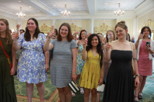 2024 graduates raise a glass of champagne as President Paino makes his toast. Photo by Karen Pearlman.