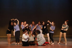 Madeline (second from left) hangs out with members of the Performing Arts Company after its big show in fall 2023. Photo by Chenin Gruber.