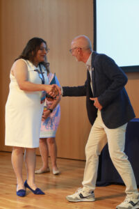 Simran Kaur-Colbert '11 shakes President Paino's hand after receiving the Outstanding Young Alumni Award. Photo by Karen Pearlman.