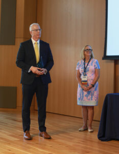 Jay Dugger '90 receives the Distinguished Alumni Award while Jenifer Blair '82 looks on. Photo by Karen Pearlman.