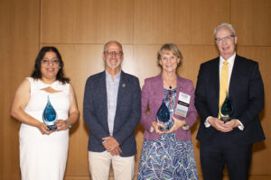 2024 Alumni Award recipients Simran Kaur-Colbert '11, Susan Leavitt '83, and Jay Dugger '90 with President Troy Paino at UMW's Alumni Awards ceremony on June 1 during Reunion Weekend. Photo by Karen Pearlman.