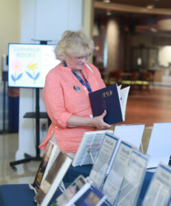 Joan Darby '74 browses books during an alumni author meet-and-greet at 2024's Reunion Weekend. Photo by Karen Pearlman. 