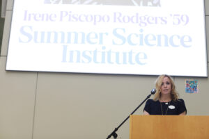 Board of Visitors Rector Devon Williams Cushman '93 reads aloud the board resolution naming the Summer Science Institute in Irene Piscopo Rodgers' honor. Photo by Karen Pearlman.