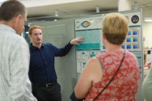 Ryan Cloughley shares his poster about his research on the impact of noise on humidity retrievals. Photo by Karen Pearlman.