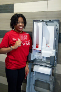 Each Aunt Flow machine can hold 50 tampons and 50 pads (which read 'Changing the world one cycle at a time' on the packaging). Machines also feature Braille for visually impaired students and are easy to reach for those who are physically impaired. Photo by Sam Cahill.