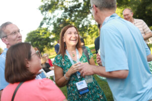 Renee Kuntz '85 (center, chatting with friends at Reunion Weekend in 2022) recently made a pledge that helped UMW's Beyond the Classroom Endowment pass the $1 million mark to help Mary Washington students engage in high-impact learning experiences like study abroad, internships, and undergraduate research. Photo by Karen Pearlman.