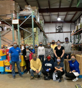 Kristen (standing, black shirt) working at the Fredericksburg Food Bank with other members of the Rappahannock Rotary Club. Photo courtesy of Kristen Ramey.