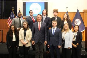 UMW alumna Kristen Ramey '17 (front row, second from left) poses for a photo with Gov. Glenn Youngkin and other Virginia Management Fellows. As a member of VMF's sixth cohort, Kristen is putting the business and public policy background she gained from Mary Washington to work as she explores careers in state public service. Photo courtesy of Kristen Ramey.