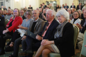 From left: Vice President for Advancement and Alumni Engagement Katie Turcotte, Kelly Paino, President Troy Paino, Distinguished Professor Emeritus Bill Crawley, and Dr. Terrie Young Crawley '77 listen as Scott Harris '83 announced the new Great Lives season on Tuesday. Photo by Karen Pearlman.