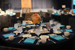 With a study abroad theme, tables were decorated with globes, suitcases, and postcards from far-flung locales across the globe. Photo by Karen Pearlman.