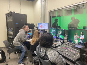 From left: Audra Young, Mariah Misch, and Pearl Lee prepare to broadcast an episode of 'Are We Live?' from the Charnoff Production Studio, using the older technology that had been in place since the HCC opened in 2014. The new broadcast panel increases functionality, Cartland said, giving students access to cutting-edge tools that were not available with the previous technology. Photo courtesy of Cartland Berge.