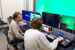 Cartland (left) and Steve try out the new broadcast panel, which allows students and faculty to tap into digital tools they didn't have access to before. Photo by Sam Cahill.