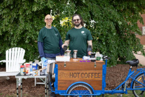 From left: Ray Tuttle, UMW’s health promotions and student success specialist, and Devin Walsh, UMW's peer recovery specialist, run Eagles in Recovery, a program that supports Mary Washington students working to overcome substance and alcohol addiction. A Fund for Mary Washington Impact Grant has supported Devin's position, which also oversees the recovery coffee bike (seen here), providing beverages, education, and outreach to the campus community. Photo by Parker Michel Boyce.