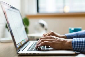 Unsplash image - hands on a Mac laptop keyboard. 