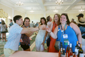 2014 alumni, including Director of Annual Giving Shelby Orlando '14 (right), sample Virginia vintages at the wine, beer, and cider tasting during 2024's Reunion Weekend. Photo by Karen Pearlman.