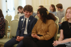 Shadwick Yoder '25, vice president of the Student Government Association, and Amira Said '26, UMW Senate vice president, chat in between presentations, while Callie Harkins '26 (right), editor of The Weekly Ringer student newspaper, looks on. Photo by Karen Pearlman.