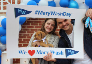 Student giving more than doubled from last year's event, and many participated in activities at the Mary Wash Day headquarters on the Cedric Rucker University Center patio on April 2. Here, two students take photos at the selfie station with a puppy brought to campus by Old Dominion Humane Society.
