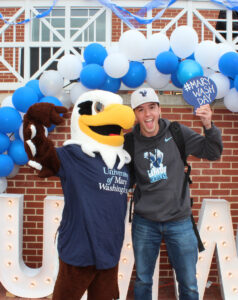 A student poses for a photo with UMW mascot Sammy D. Eagle at the Mary Wash Day headquarters on April 2.