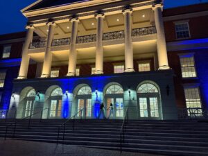 Students celebrate a successful Mary Wash Day on the steps of the Cedric Rucker University Center, which was illuminated in Mary Wash blue on April 2.