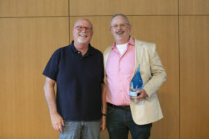 Rob Eastman-Mullins '00 (right) poses for a photo with Professor and Chair of Theatre & Dance Gregg Stull '82. Eastman-Mullins called his former professor an 'absolute treasure' and thanked him for his support throughout his time at Mary Washington and in his career. Photo by Karen Pearlman.