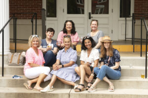 Alumni pose for a picture after the Virginia wine, beer, and cider tasting, held in Monroe Hall this year. Photo by Karen Pearlman.