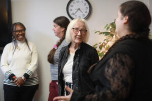 Foreground: Betty Talley (left) chats with Melissa Palguta, a staff counselor in the Talley Center. Background: Glorya Askew (left), a licensed clinical social worker and trainee, and Krysta Thomas, a staff counselor, converse. Photo by K Pearlman Photography.