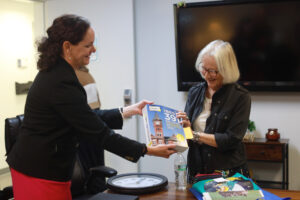 Dr. Juliette Landphair (left), associate vice president for health and well-being at Mary Washington, shows Betty Talley a copy of Princeton Review's 'The Best 391 Colleges' guide for 2026, which lists Mary Washington at #15 Best Student Support and Counseling Services. Photo by K Pearlman Photography.