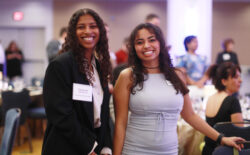 Two college students smiling for the camera.
