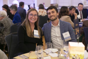 A young couple seated at a table in the ballroom.
