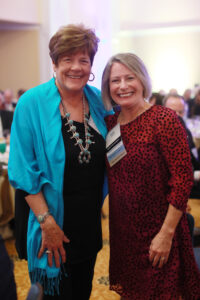 A party guest, Linda Coker, with Kelly Paino, wife of President Troy Paino.