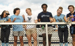 UMW student-athletes standing on the bleachers.