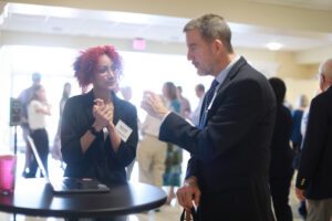 A student shares research with a donor.