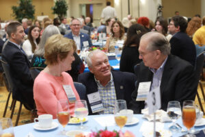 Two donors chatting with Assistant Vice President for Gift Planning Emeritus Jan Clarke.