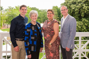 A group of four alumni from different generations.
