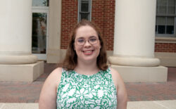 Student smiling in front of Virginia Hall.