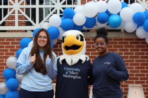 Two students and UMW mascot Sammy D. Eagle.