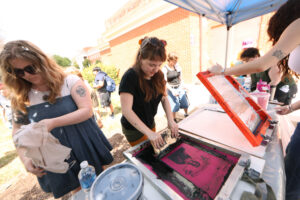 Two students screen-print.