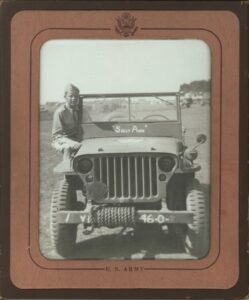A black and white photo of Sallie's father and his jeep, with the name 'Sally Ann' on it (spelled wrong).