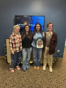 Four students in front of a screen that reads Fall 2025 Lively Project.