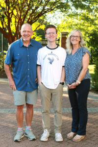 Two parents and their student wearing a Mary Washington T-shirt.