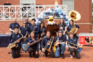 The UMW pep band with their instruments and UMW mascot Sammy D. Eagle.